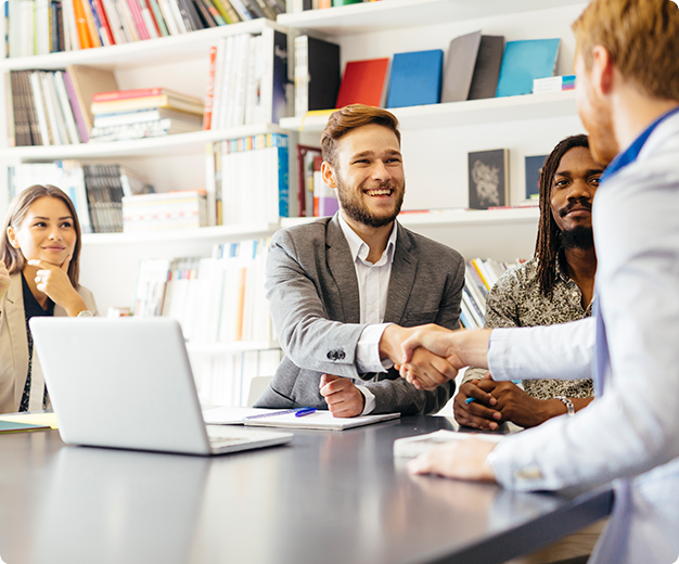 Two men in a meeting shaking hands